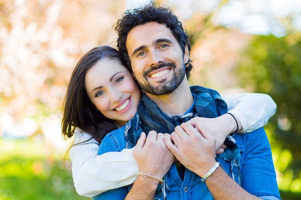 Two smiling people who got teeth whitening in Calgary