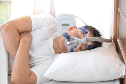 senior man wearing Cpap mask sleeping