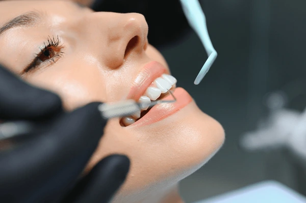 doctor examining patients teeth closeup