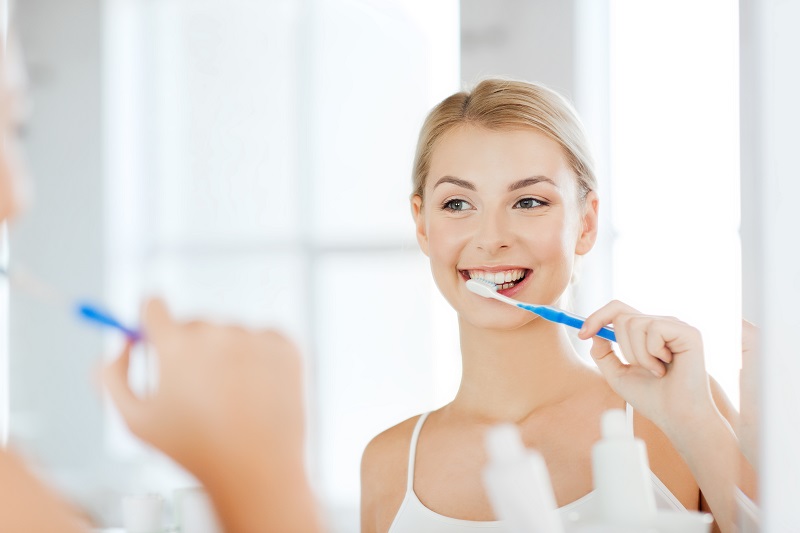 woman brushing her veneers