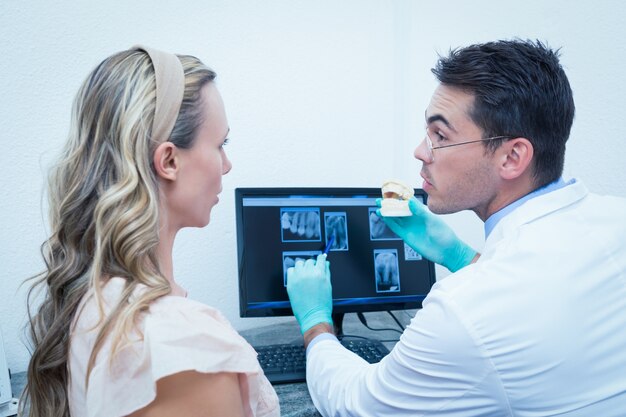 dentist-showing-woman-prosthesis-teeth